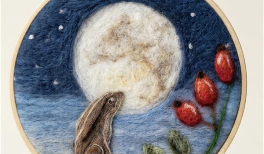 2D needle felted picture of a moon gazing hare with rose hips