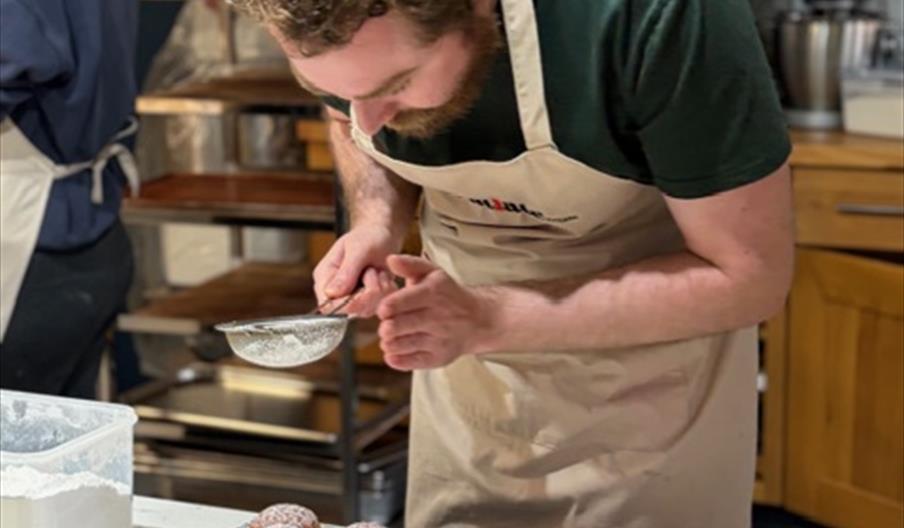 Man decorating doughnuts