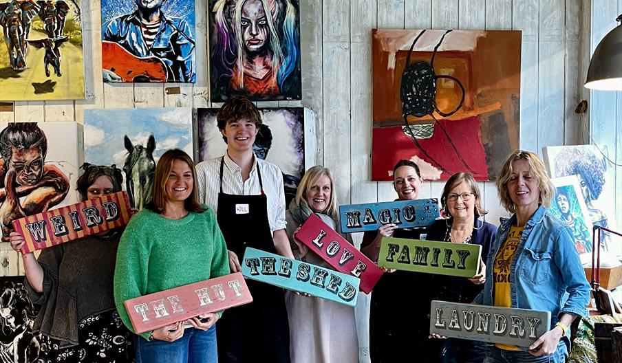 people holding up their signs after a make a sign workshop in Norwich