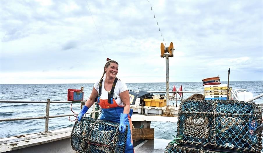 Ashley Mullenger on her fishing boat in Norfolk
