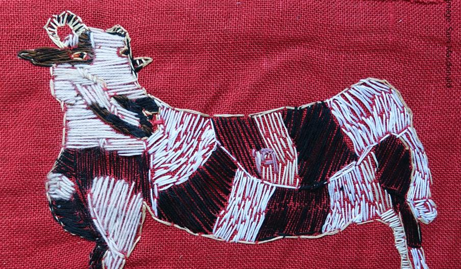 Barrington Farm open Studio poster of an embroidered white sheep on a red background