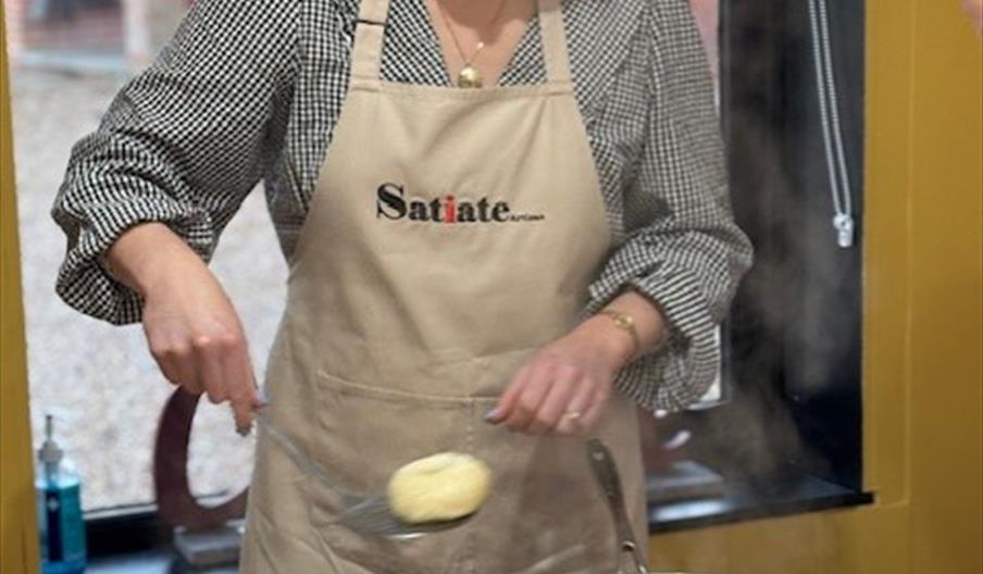 Person poaching bagels