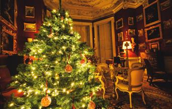 Opulent red Cabinet Room at Felbrigg Hall decorated for Christmas