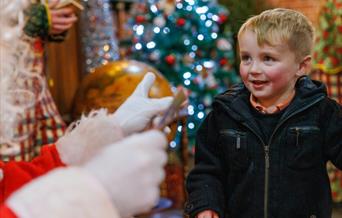 Young boy with Father Christmas at ROARR!