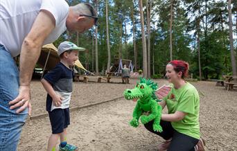 Child meeting puppet at bewilderwood