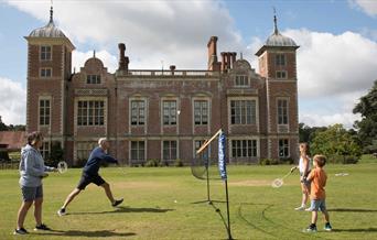 Family of four play a game of badminton at Blickling Estate