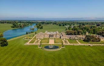 An aerial shot of the South Front of Holkham Hall on a beautiful sunny day.