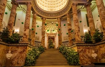 The Marble Hall at Holkham decorated for Christmas.