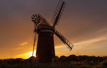 Sunset behind Horsey Windpump with the mill and reeds silhouetted