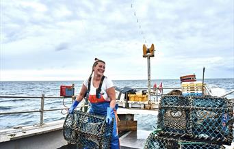 Ashley Mullenger on her fishing boat in Norfolk