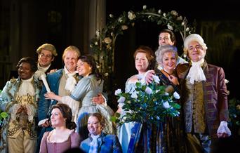 The cast of Mozart's Marriage of Figaro posed mid performance.