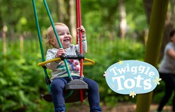Toddler on swing at bewilderwood