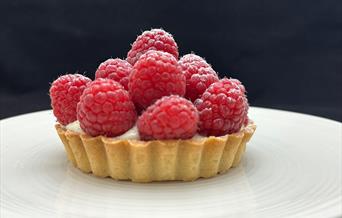Raspberry tart on a buttery crisp tart case