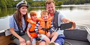 Family on a Day Boat in the Broads National Park taking a selfie