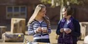 Visitors enjoying a cup of tea outside at Blickling Estate, Norfolk