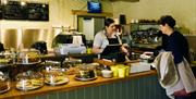 A customer and member of staff in the Muddy Boots café at Blickling Estate, Norfolk
