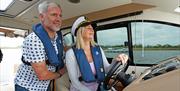 Couple driving a Cruiser in the Broads National Park