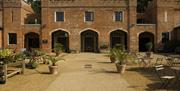 The stable courtyard with plant sales and outside seating for the Squire's Pantry tea room.