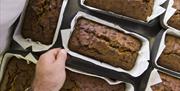 Fruit cakes being made in the kitchen at the Squire's Pantry tea room at Felbrigg Hall, Norfolk