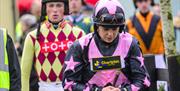 Jockeys heading out to the Parade Ring to meet the trainers and mount their horses before racing