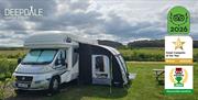 Motorhome with awning on a Woodview pitch at Deepdale Camping & Rooms on the beautiful North Norfolk Coast