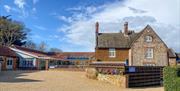 Caley Hall Hotel entrance with blue sky.