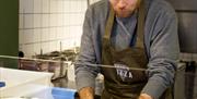 Watch pizzas hand-stretched at Eric's Pizza in Holt