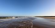 Waves lapping at Holkham Beach