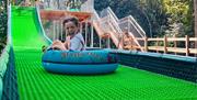 Fossil Falls is ROARR!'s newest attraction coming on 18th July 2026. A 107 metre action packed inflatable tubing slide, for guaranteed thrills!