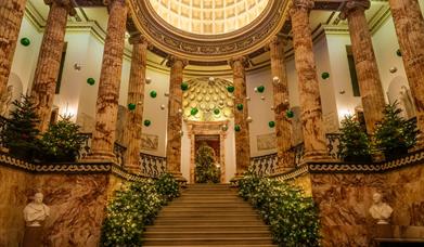 The Marble Hall at Holkham decorated for Christmas.