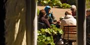 Visitors sat outside the Muddy Boots café at Blickling Estate, Norfolk