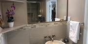 En-suite with walk in rain shower and stone sink