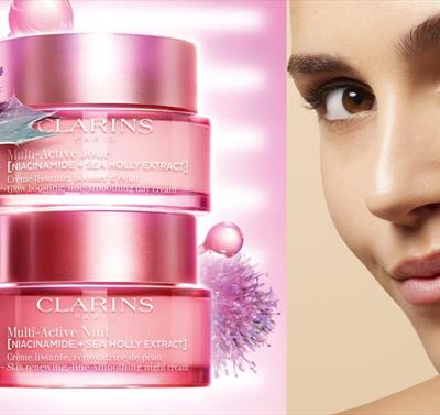Photo of a model and a stack of Clarins products