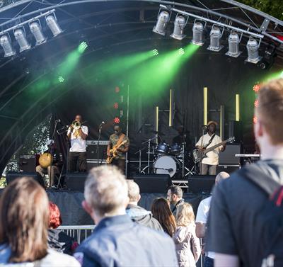 People watching a band on stage at Riverside Festival.