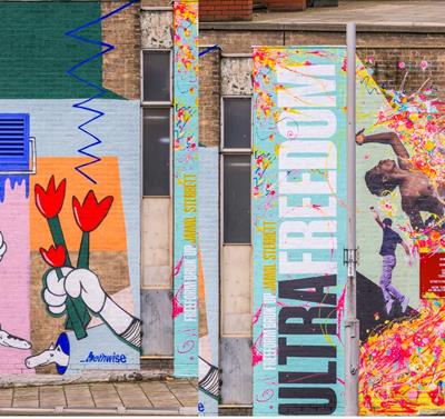 Image of two murals spray painted on to Nottingham buildings