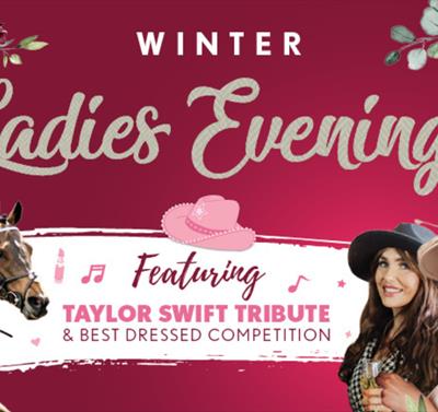 Female racegoers enjoy the excitement of an evening at the races