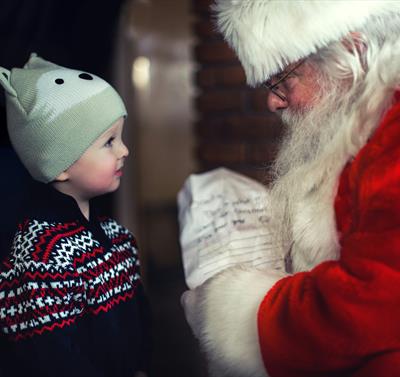 Picture of small child meeting Santa