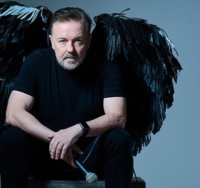 Photo of Ricky Gervais with black angel wings