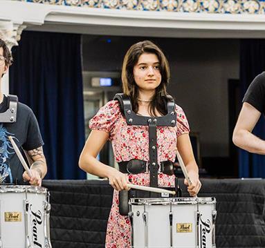 people playing marching drums