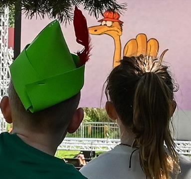 children watching a film outside