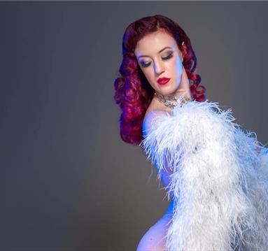 Photo of burlesque perfromer wrapped in a feather boa