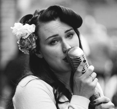 woman singing into a mic
