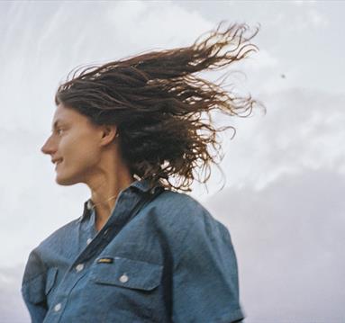 Image shows Sophie Jamieson on against dramatic sky on blustery day