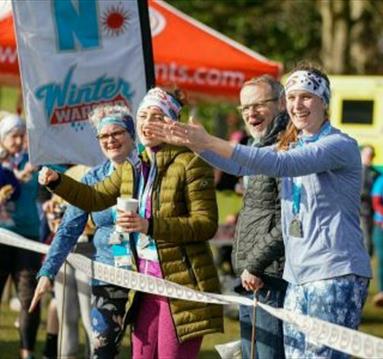 Photo of supporters at the side of the running track