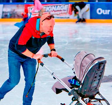 Photo of a dad with a stroller on the ice