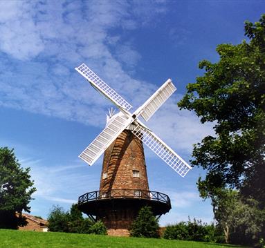 Image is of Green's Windmill with blue summer sky behind