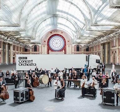 A graphic showing a deconstructed orchestra set-up in a grand room.