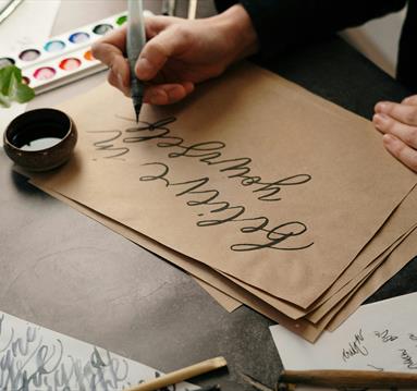 Photo of a person practicing drawing with ink