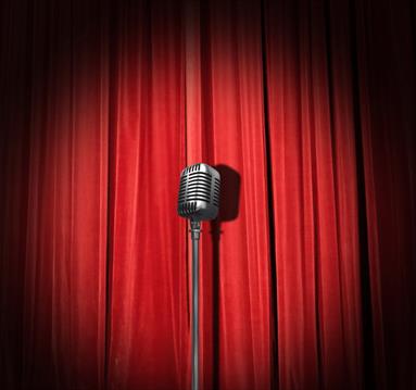 Microphone in front of a red stage curtain