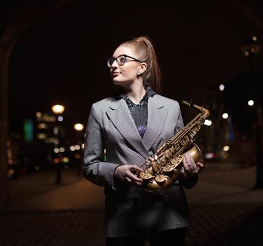 Jess Gillam holds her saxophone ready to perform